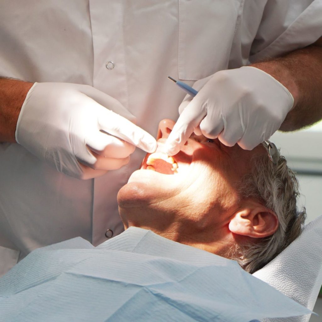 male patient getting his teeth examined by a dentist