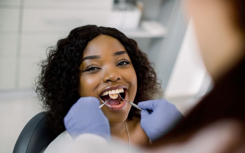Women getting her teeth inspected by dentist